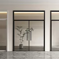 Modern Glass Double Doors With Black Frames And Decorative Plant In Interior Space