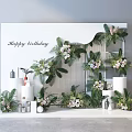 Happy Birthday Party Decor With Floral Arrangements Green Plants And White Background