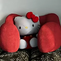 Adorable Hello Kitty Doll On Red Chair With White Body Red Bow And Patterned Cushion