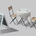 Round Table with Wooden Chairs Checkered Tablecloth Cups Open Book and Chalkboard Sign
