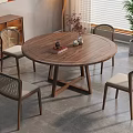 Round Wooden Dining Table Set With Wicker Back Chairs And Light Cushions In Modern Home