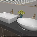 White Square and Oval Washbasins with Golden Faucets Green Plant on Dark Countertop