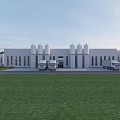 Industrial Factory Building With White Exterior Spire Topped Towers Trucks And Green Lawn