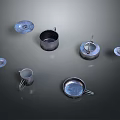 Scattered Metal Household Items Including Mugs And Plates On Dark Background