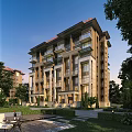 Modern Residential Building Exterior with Balconies Large Windows and Green Landscaping