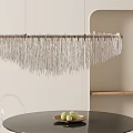 Modern Hanging Chandelier with Long White Pendants Above Black Round Dining Table
