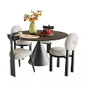 Round Dark Dining Table Set With Four Light Upholstered Chairs Green Vase And Yellow Flowers