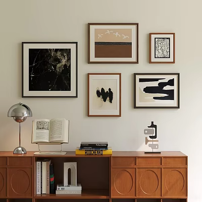 Stylish Photo Wall With Framed Artworks Above Wooden Cabinet Table Lamp Books And Decorative Object 3d model