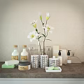 Elegant Bathroom Accessories with White Lilies Vase Silver Containers and Toiletries Bottles