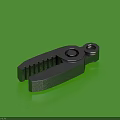Black Metal Clamp With Serrated Edges And Holes On Green Background
