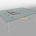 Glass Coffee Table with Transparent Top and Metal Frame Featuring a Book on Surface
