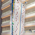 Indoor Rock Climbing Wall In Multi Story Building With Colorful Holds And Balconies