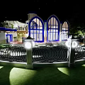Detached Villa With Blue Dome Arched Windows White Fence Green Lawn And Sunlight