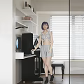 Woman Standing By Desk With Laptop Headphones And Wall Art In Room