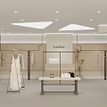 Ladies Clothing Store Interior With Fashion Display Hanging Dresses Display Table And Lighting