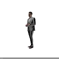 Man Standing in Gray Suit With White Shirt Against Black Background