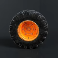 Car Tire With Black Tread And Orange Rim Detailed Close Up View
