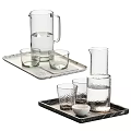 Assorted Glass Drinkware With Carafes On Marble Trays