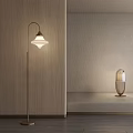 Modern Floor Lamp With Curved Metal Stand And Warm Glow In Minimalist Interior