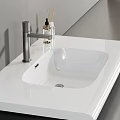 White Bathroom Wash Basin with Silver Faucet and Toiletries on Countertop