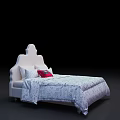 White Double Bed with Unique Headboard Design and Patterned Quilt and Red Accent Pillows