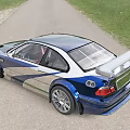 Modified Sports Car with Blue Green Camouflage Large Rear Spoiler Silver Wheels on Country Road