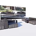 Black Outdoor Sofa Set In Modern Patio With Lush Greenery And Water Feature