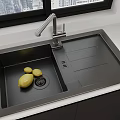 Black Kitchen Sink With Lemon Modern Faucet And Drainer On Countertop