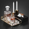 Crystal Decanter And Glasses On Gold Rimmed Tray With Cigar White Candles And Black Background