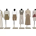Mannequins Displaying Various Stylish Clothing Outfits With Neutral Tones And Plaid Patterns