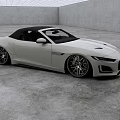 White Convertible Sports Car With Sleek Design Black Soft Top And Alloy Wheels