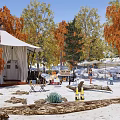 Scenic Campsite With White Tent Autumn Trees Tables Chairs And Sandy Ground