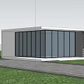 Modern Glass Entrance Gate Of Contemporary Building With Grass Trees And Car