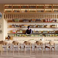 Warm Restaurant Space Featuring Bar Counter Shelves Bottles Staff Wooden Chairs Plant And Moon Decoration