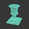 Small Grass Plants In Carved Stone Planter On Square Base With Pebbles