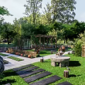 Scenic Guesthouse Building With Courtyard Terrace and Lush Greenery Surrounded by Trees