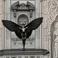 Red Haired Game Movie Character With Black Wings Glowing Energy In Ancient Architecture
