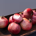Fresh Juicy Ripe Red Pink Pomegranates Arranged on a Wooden Plate