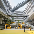 Modern School Building With Multi Level Walkways Yellow Staircases Green Plants And Active Students