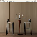 Round Bar Table With Two High Stools Against Wooden Wall And Wine Bottle With Glasses