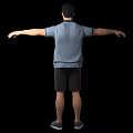 Man in blue polo shirt black shorts sports shoes with arms outstretched against black background