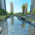 Garden Landscape With Stream Stones Flowers And Palm Trees Near Tall Buildings
