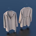 Two Beige Coats Hanging on Hangers Showing Front and Back Views on Dark Blue Background