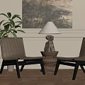 Woven Lounge Chairs with Table Lamp on Wooden Base and Wall Art in Cozy Room with Potted Plant and Wooden Flooring