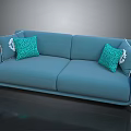 Modern Blue Sofa With Turquoise Patterned Pillows And Golden Legs