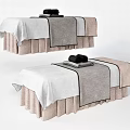 Two Comfortable Massage Beds with White Sheets Gray Towels and Beige Skirts