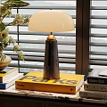 Modern Table Lamp On Stack Of Books With Floral Vase And Window Blinds