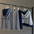Hanging Casual Hooded And Striped Tops On Hangers With Blue White And Dark Blue Colors
