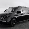 Mercedes Benz Black Van Featuring Large Windows Roof Rack And Black Rims In Outdoor Setting