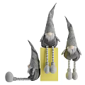 Gray Plush Dolls with Pointed Hats Striped Sleeves sitting on Yellow Block